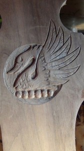 The "angry swan" carved into the back of the chair.