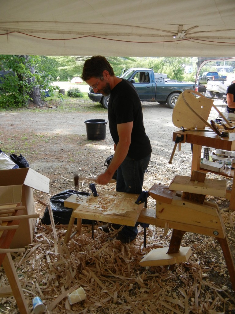 Peter Galbert demonstrating his dexterity in shaping a chair seat.