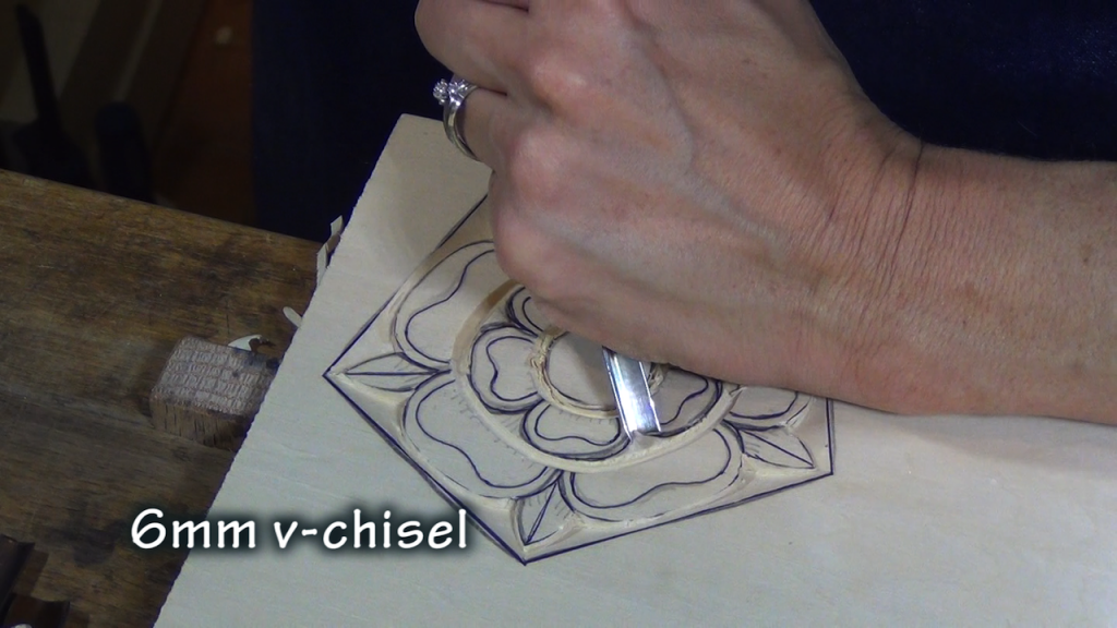 With a v-chisel, carve out the small sections between these petals.