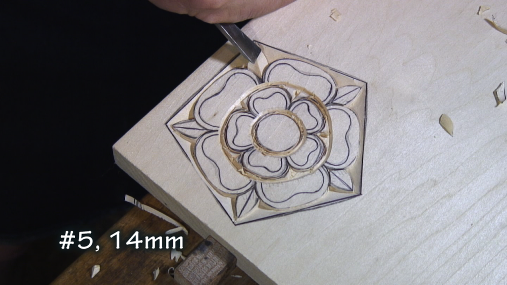 With a #5, 14mm, carve each side of the small leaf down at an angle so that it appears to go under the flower.