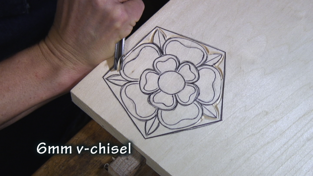 With a v-chisel, carve along the outside edge of the rose.