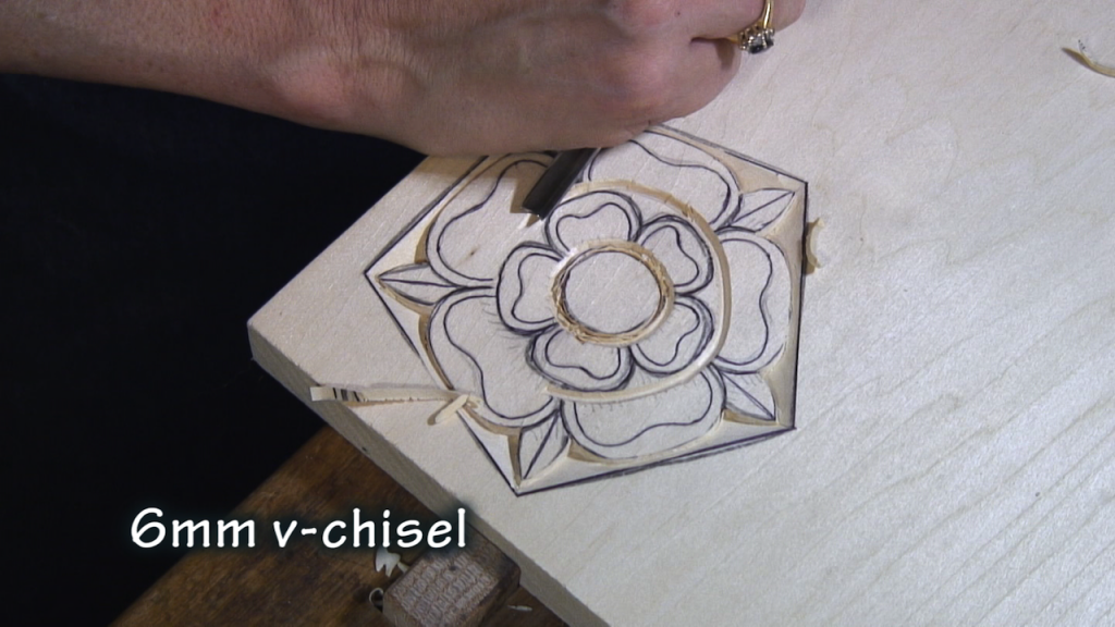 With a v-chisel, carve around the outside edge of the inner petals.