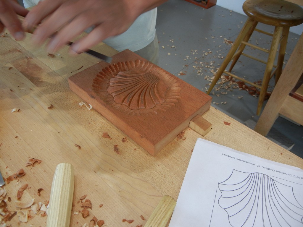Carving the scallop shell in mahogany.