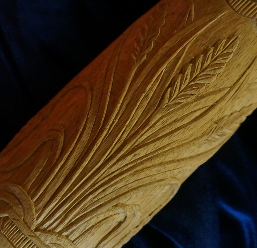 Carving a Rice Sheaf on a Bed Post